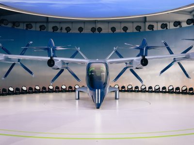 Protótipo de aeronave elétrica de pouso e decolagem vertical, com hélices, exposto em ambiente interno